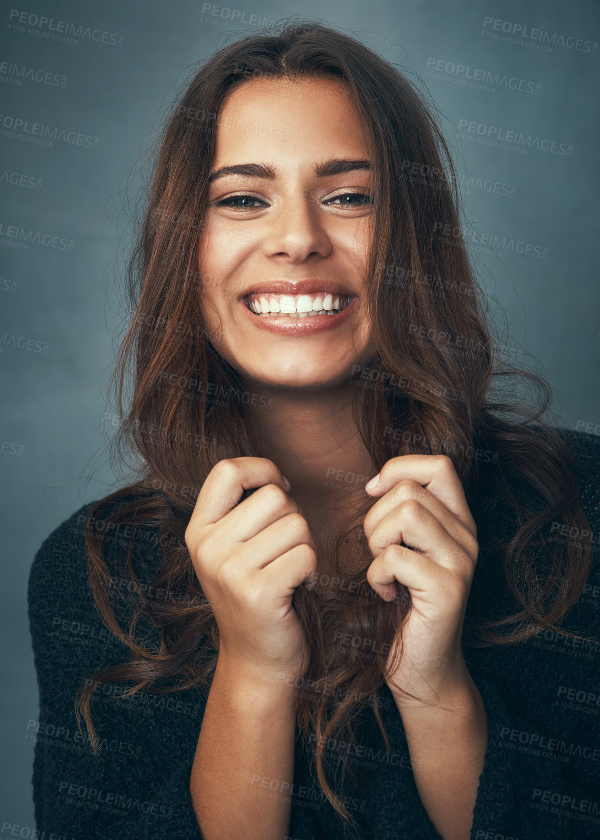 Buy stock photo Portrait of a beautiful young woman smiling against a gray background in studio