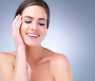 Buy stock photo Cropped shot of a beautiful young woman touching the soft skin on her face