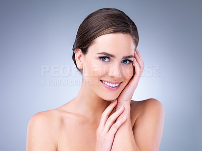 Buy stock photo Cropped shot of a beautiful young woman touching the soft skin on her face