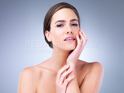 Buy stock photo Cropped shot of a beautiful young woman touching the soft skin on her face