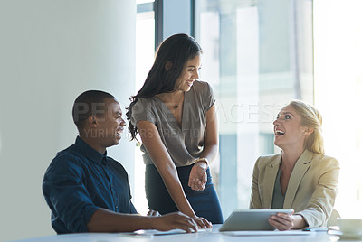Buy stock photo Cropped shot of a group of colleagues laughing while having a discussion in an office