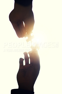 Buy stock photo Cropped shot of two people holding puzzle pieces together