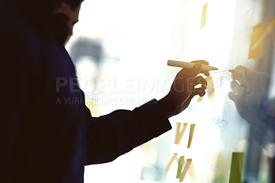 Buy stock photo Cropped shot of a businessman writing notes on a glass wall in an office