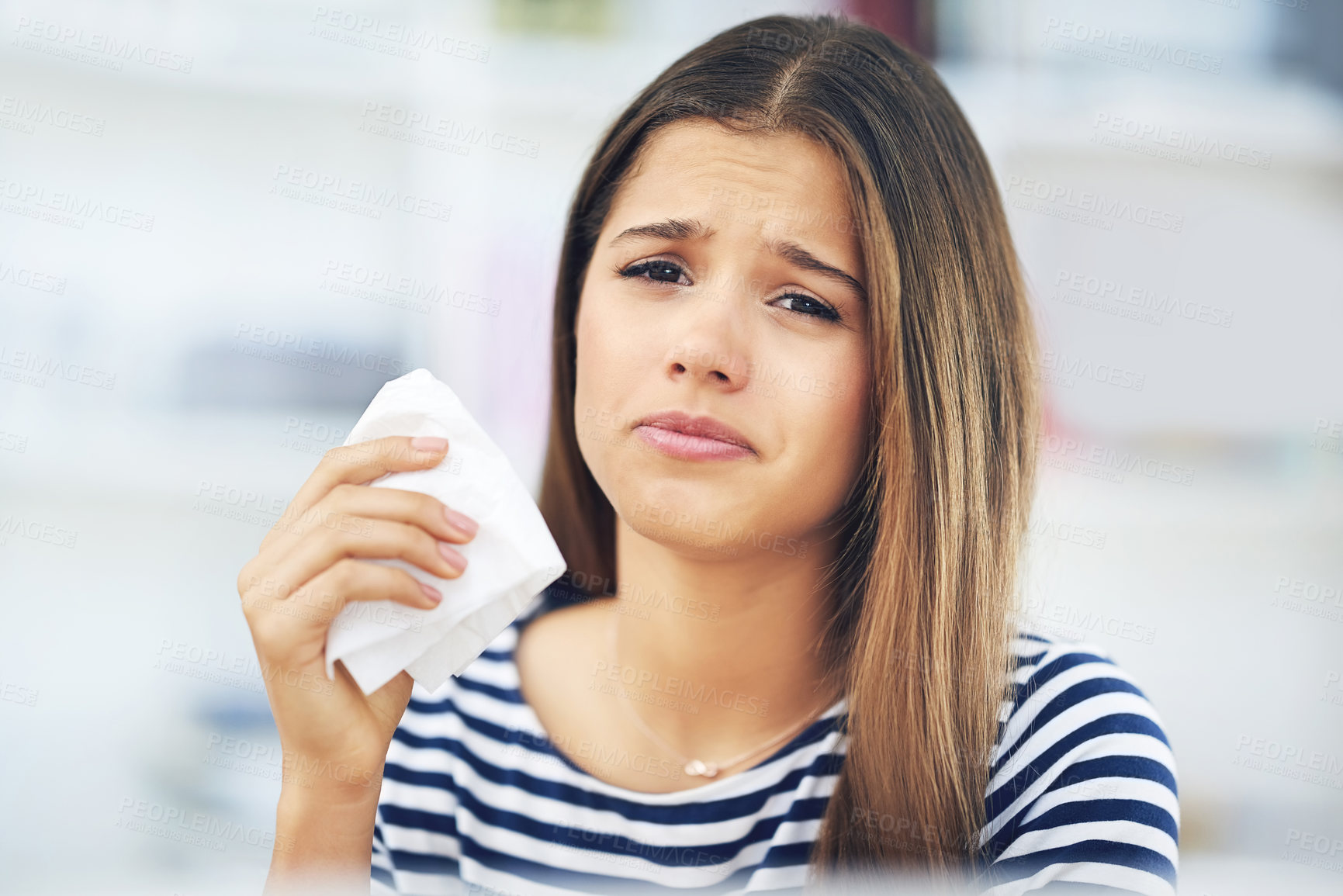 Buy stock photo Young, woman and sick with tissue in flu season, allergies or infection in home. Female student, unhappy or soft paper for allergy or virus in living room, FLIRT COVID and mucus congestion or fever