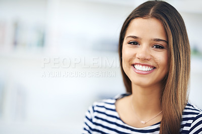 Buy stock photo Portrait of an attractive young woman smiling and relaxing at home