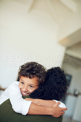 Buy stock photo Cropped shot of a little boy hugging his mother at home