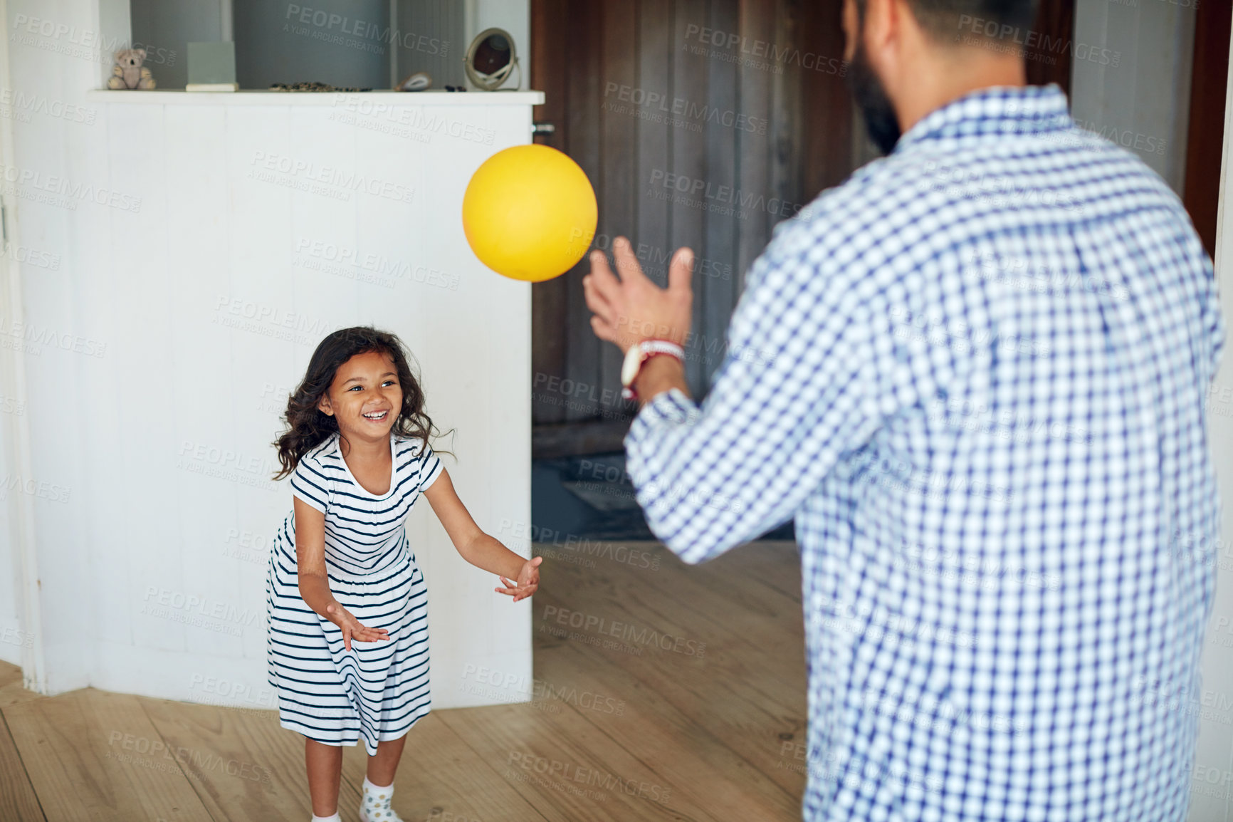 Buy stock photo Father, girl and play ball in home with smile for bonding, care or connection with throw in living room. Dad, daughter and happy together for learning, development or excited for love in family house