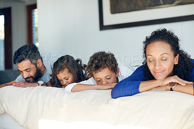 Buy stock photo Cropped shot of a family lying down on a bed with their eyes closed at home