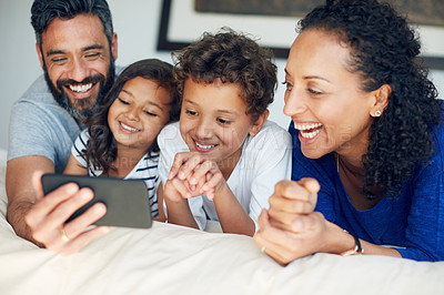 Buy stock photo Cropped shot of a happy family taking a selfie together at home
