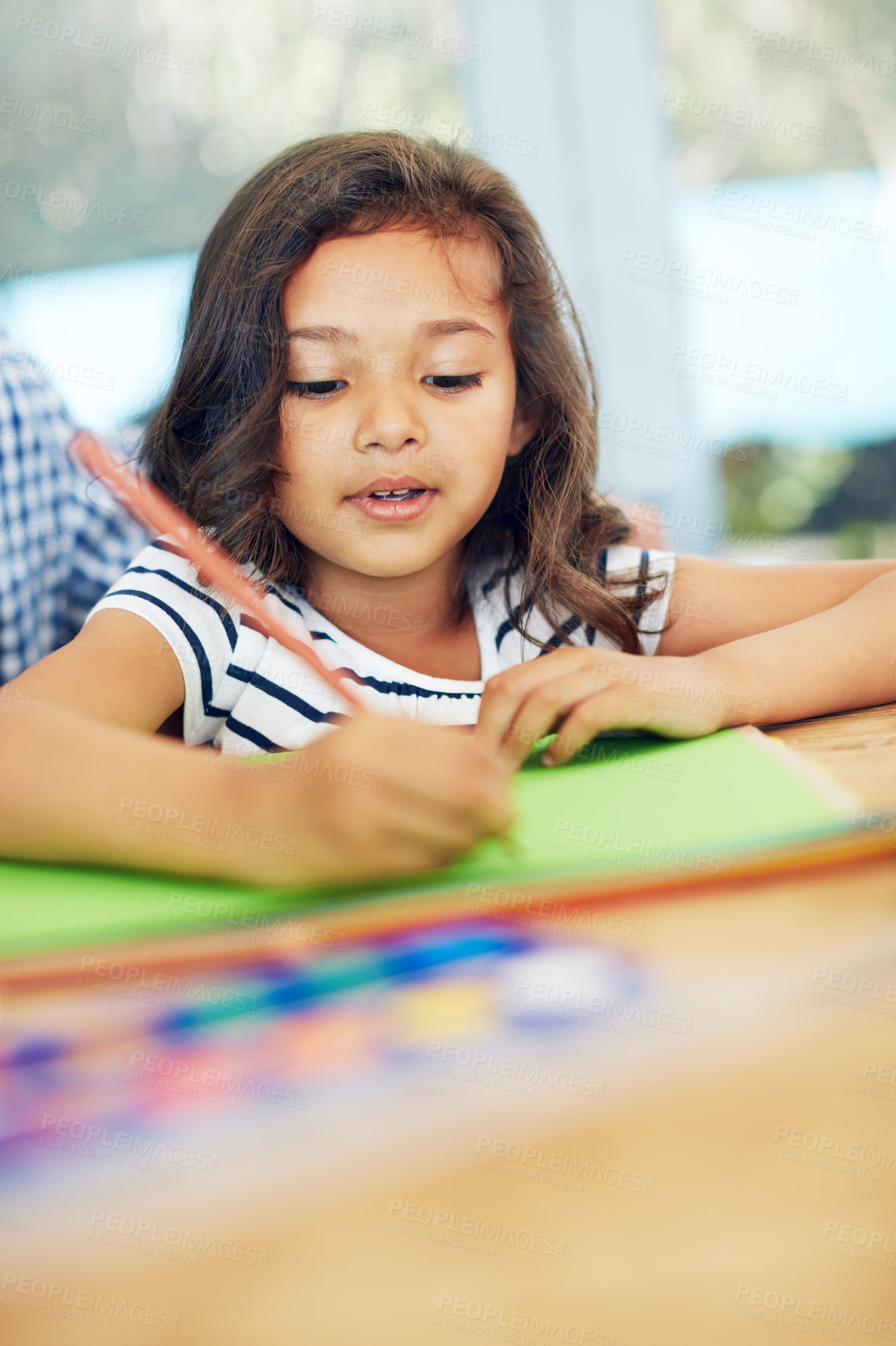 Buy stock photo Cropped shot of a little girl colouring in at home