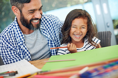 Buy stock photo Cropped shot of a father and daughter colouring in together at home