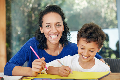 Buy stock photo Portrait of a mother and son colouring in together at home