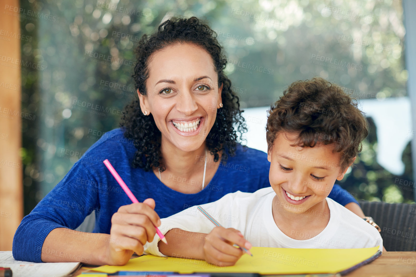 Buy stock photo Portrait of a mother and son colouring in together at home