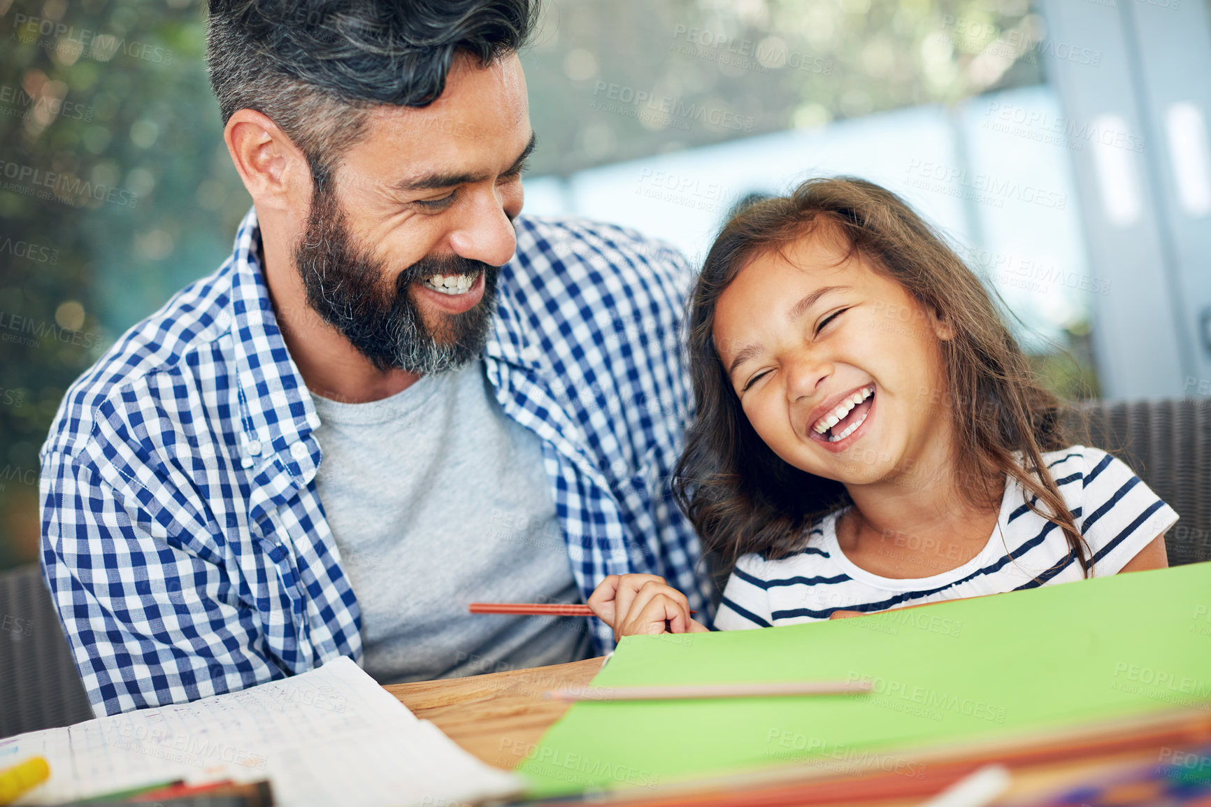 Buy stock photo Laughing, father and daughter papers on table together for learning, playing and development in home. Happy, man and girl child with notes for support, education and teaching in house with love