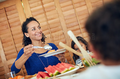 Buy stock photo Shot of a happy family gathered around their table for a meal