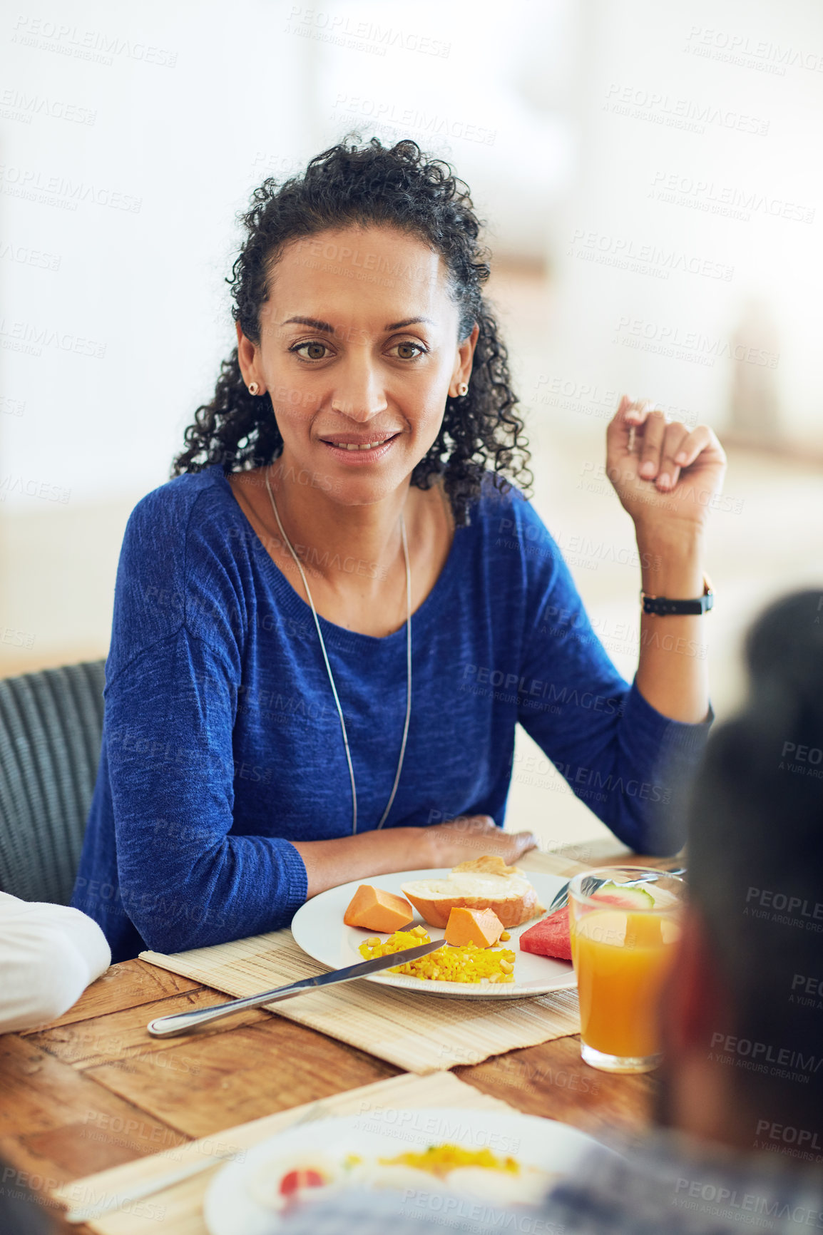 Buy stock photo Shot of a happy family gathered around their table for a meal