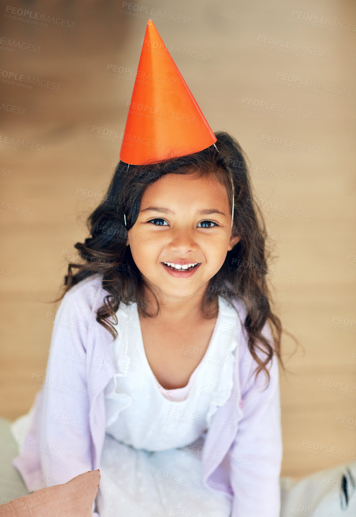 Buy stock photo Portrait of a cute little girl wearing a party hat at home