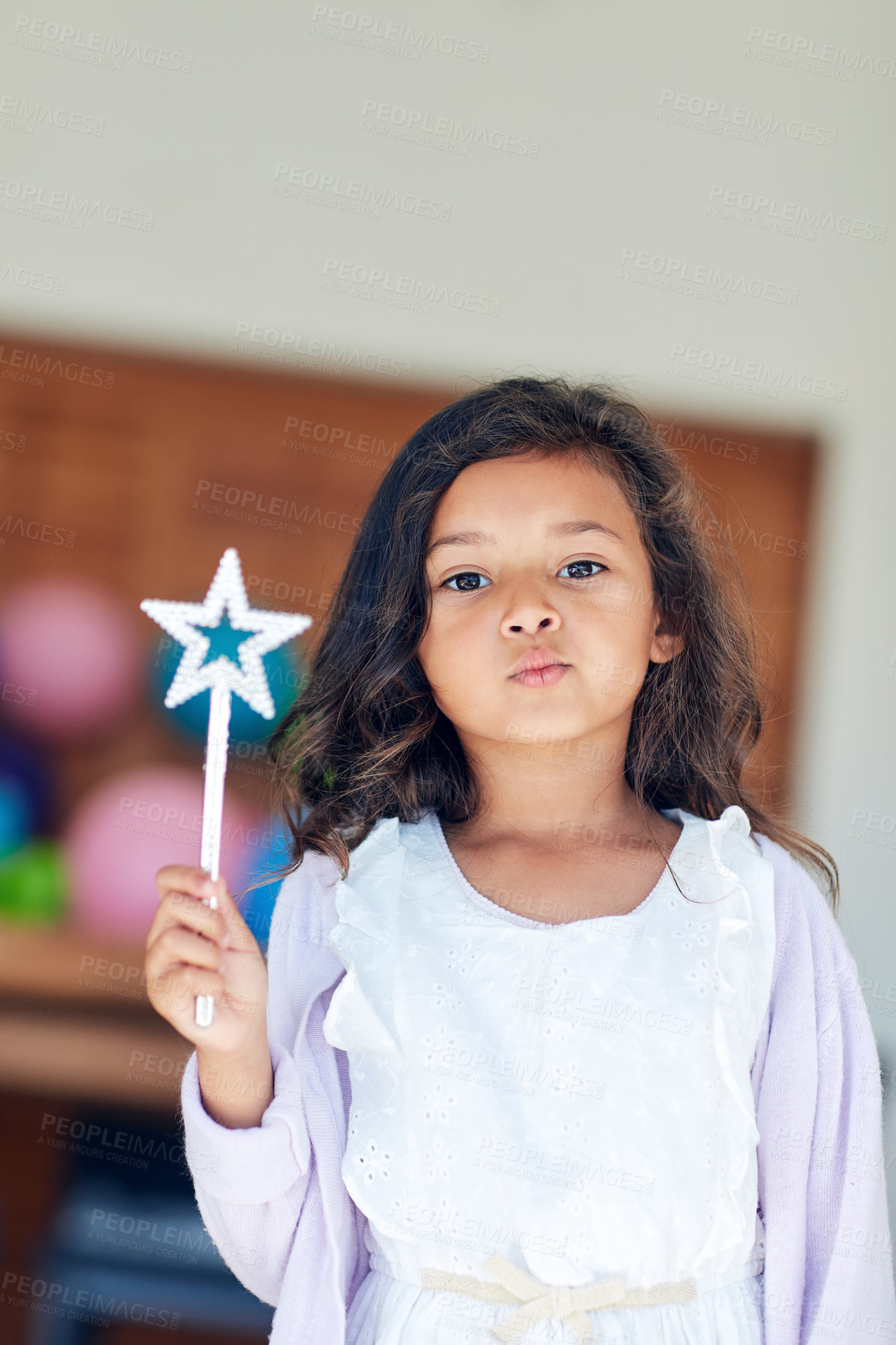 Buy stock photo Portrait of a cute little girl playing with a fairy wand at home