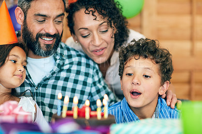 Buy stock photo Shot of a happy little boy celebrating his birthday with his family at home