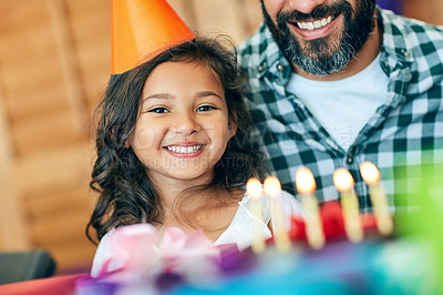 Buy stock photo Portrait of a cute little girl celebrating her birthday with her parents at home