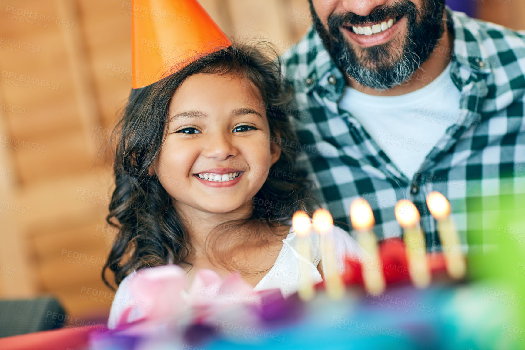 Buy stock photo Portrait of a cute little girl celebrating her birthday with her parents at home