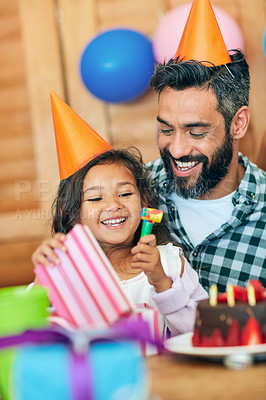 Buy stock photo Shot of a cute little girl celebrating her birthday with her parents at home