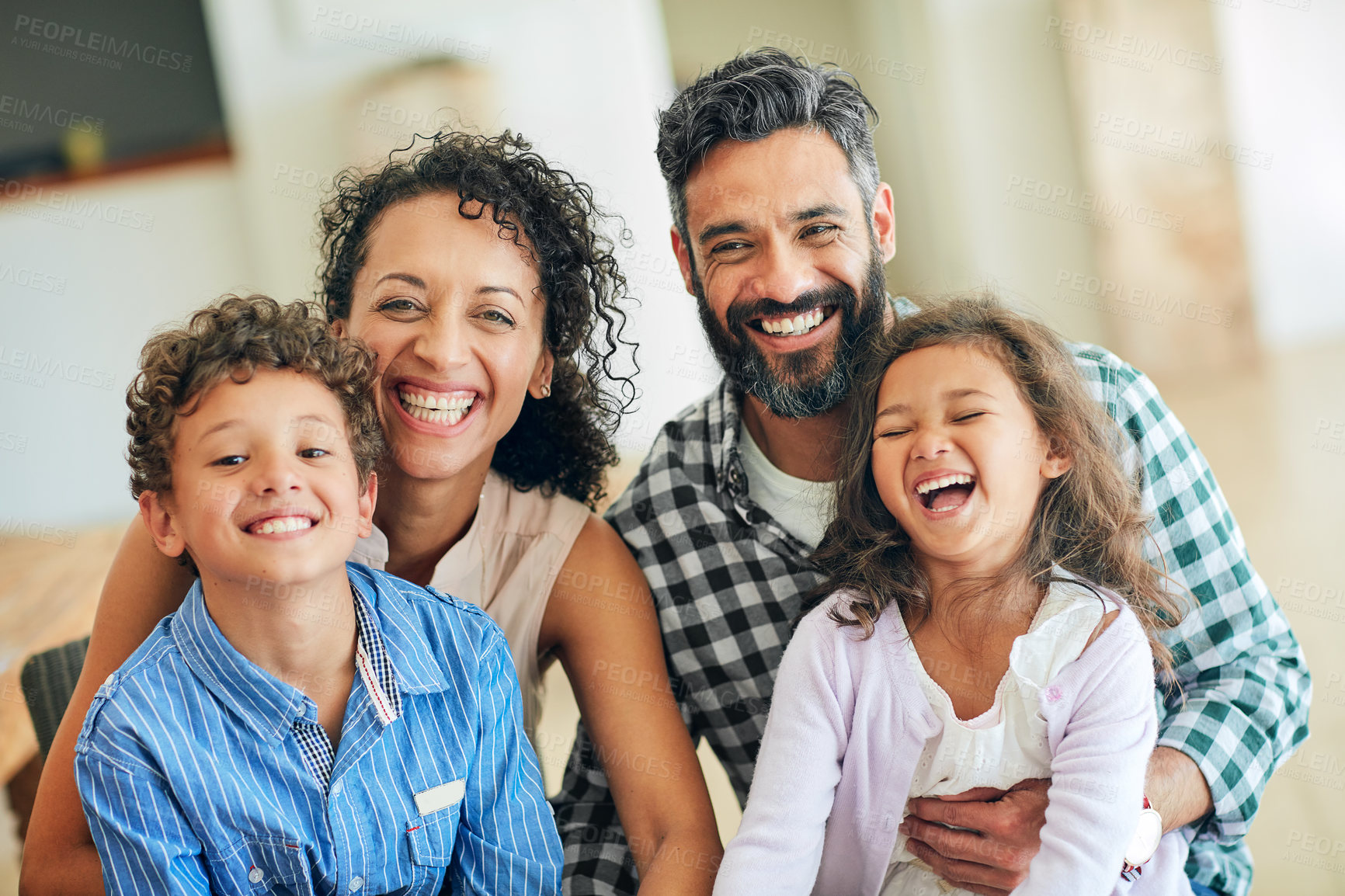 Buy stock photo Portrait of a happy family with young children posing together at home