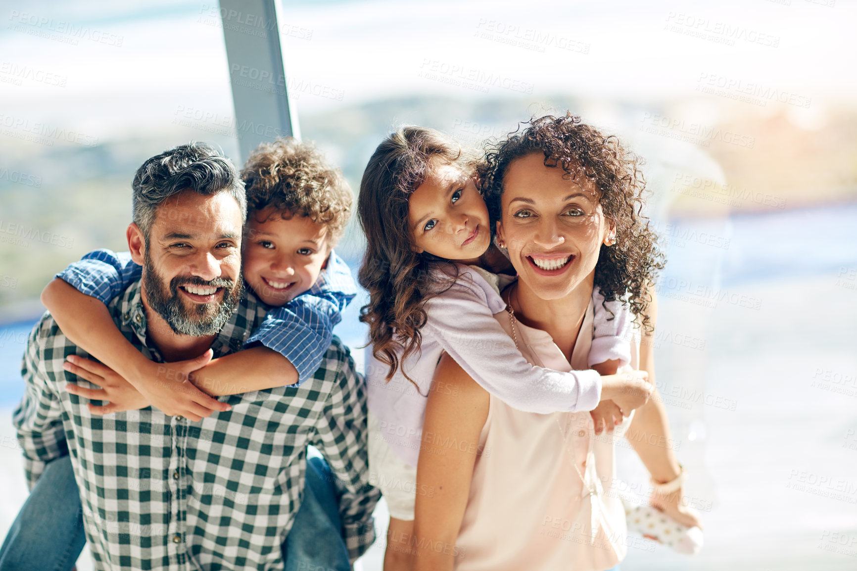 Buy stock photo Portrait of a happy family with young children posing together at home