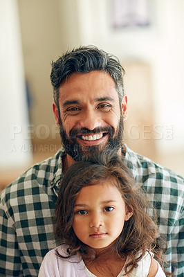 Buy stock photo Portrait of a happy man posing with his adorable daughter on his lap at home