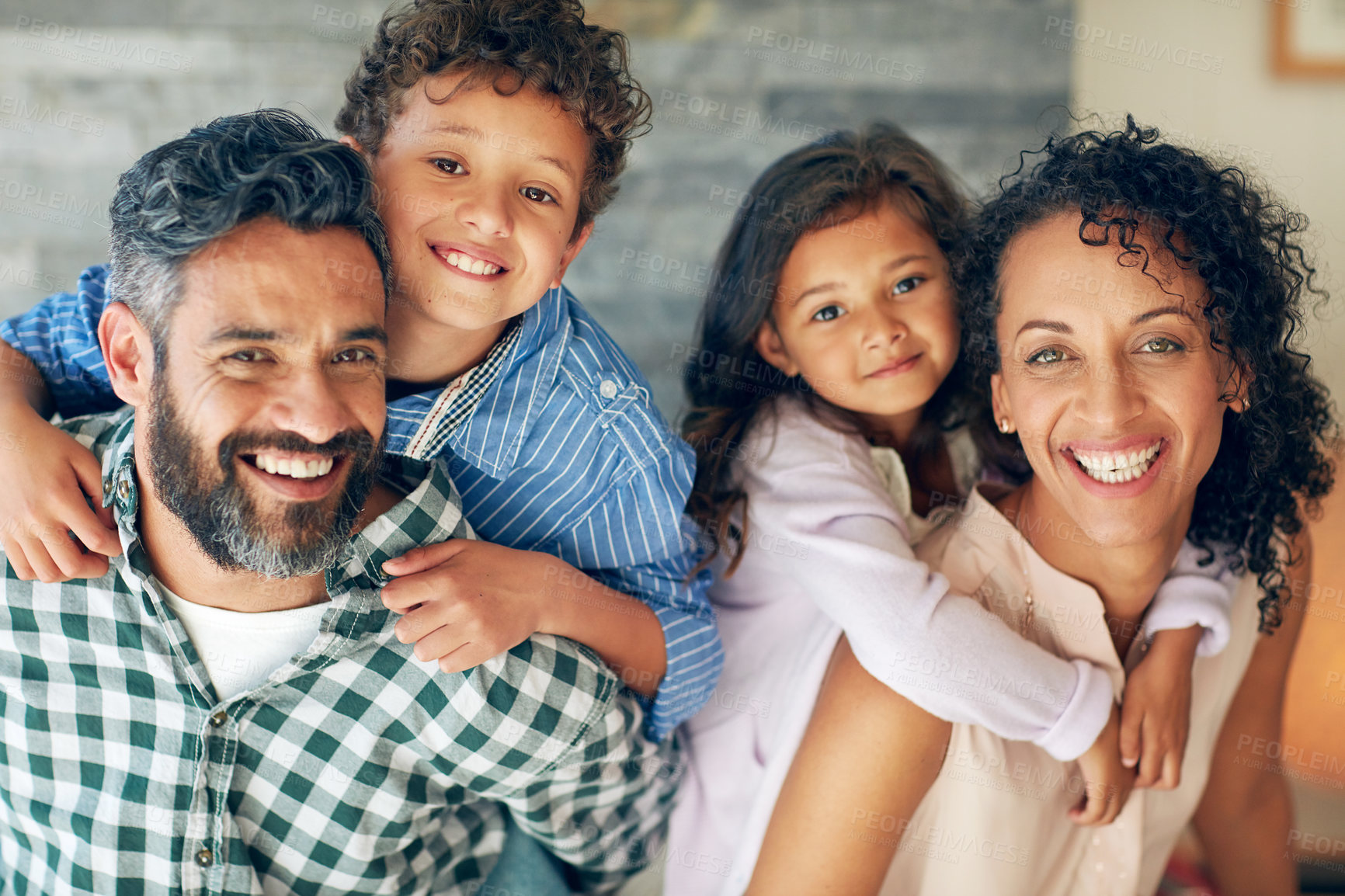 Buy stock photo Portrait of a happy family with young children posing together at home