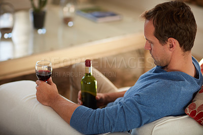 Buy stock photo Cropped shot of a mature man drinking wine at home