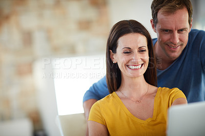 Buy stock photo Cropped shot of a mature couple using a laptop together at home