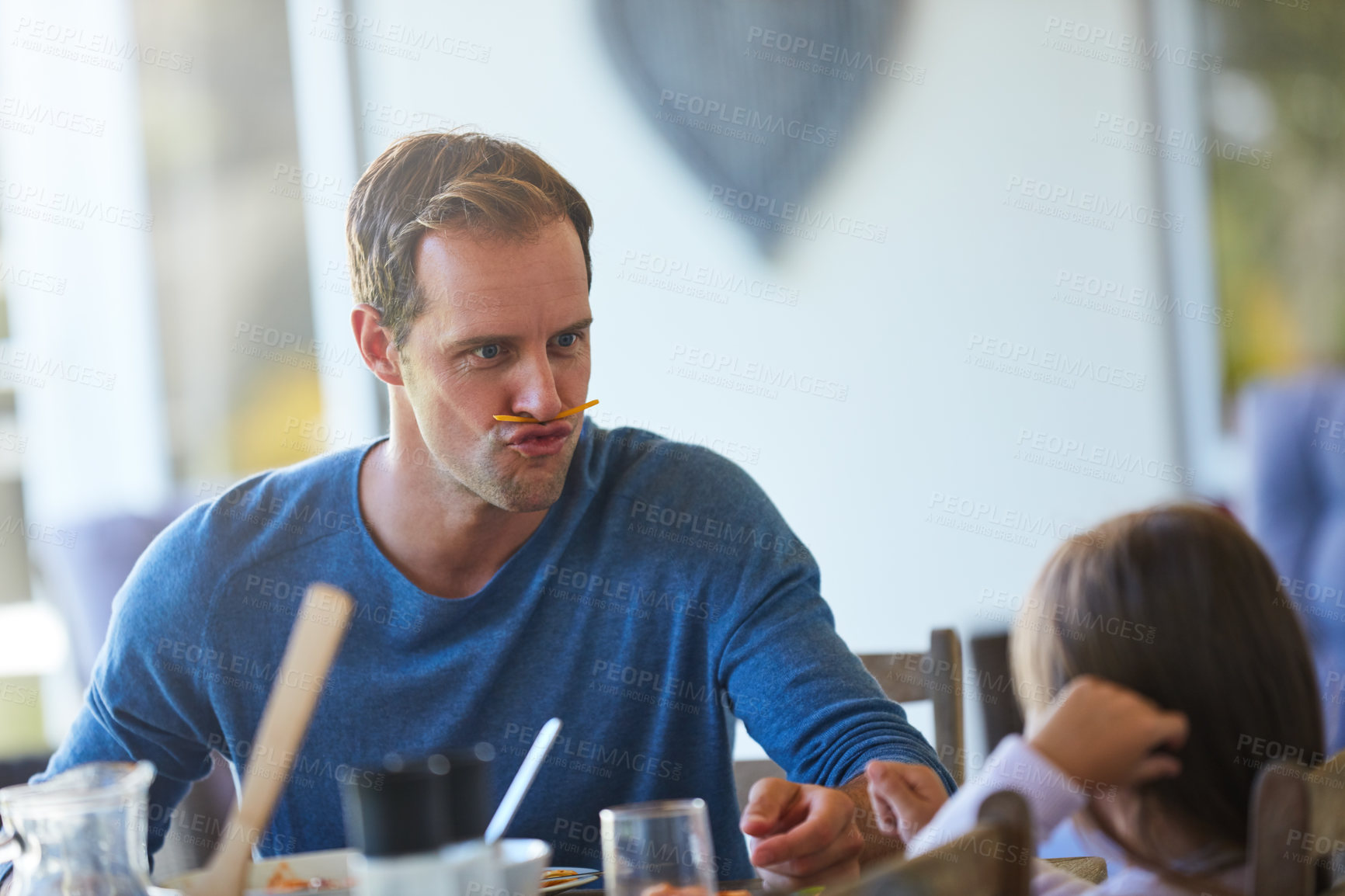Buy stock photo Cropped shot of a father and his little daughter enjoying a meal together at home