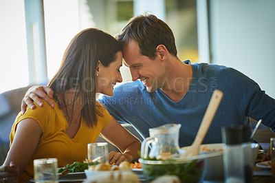 Buy stock photo Cropped shot of a mature couple enjoying a meal together at home