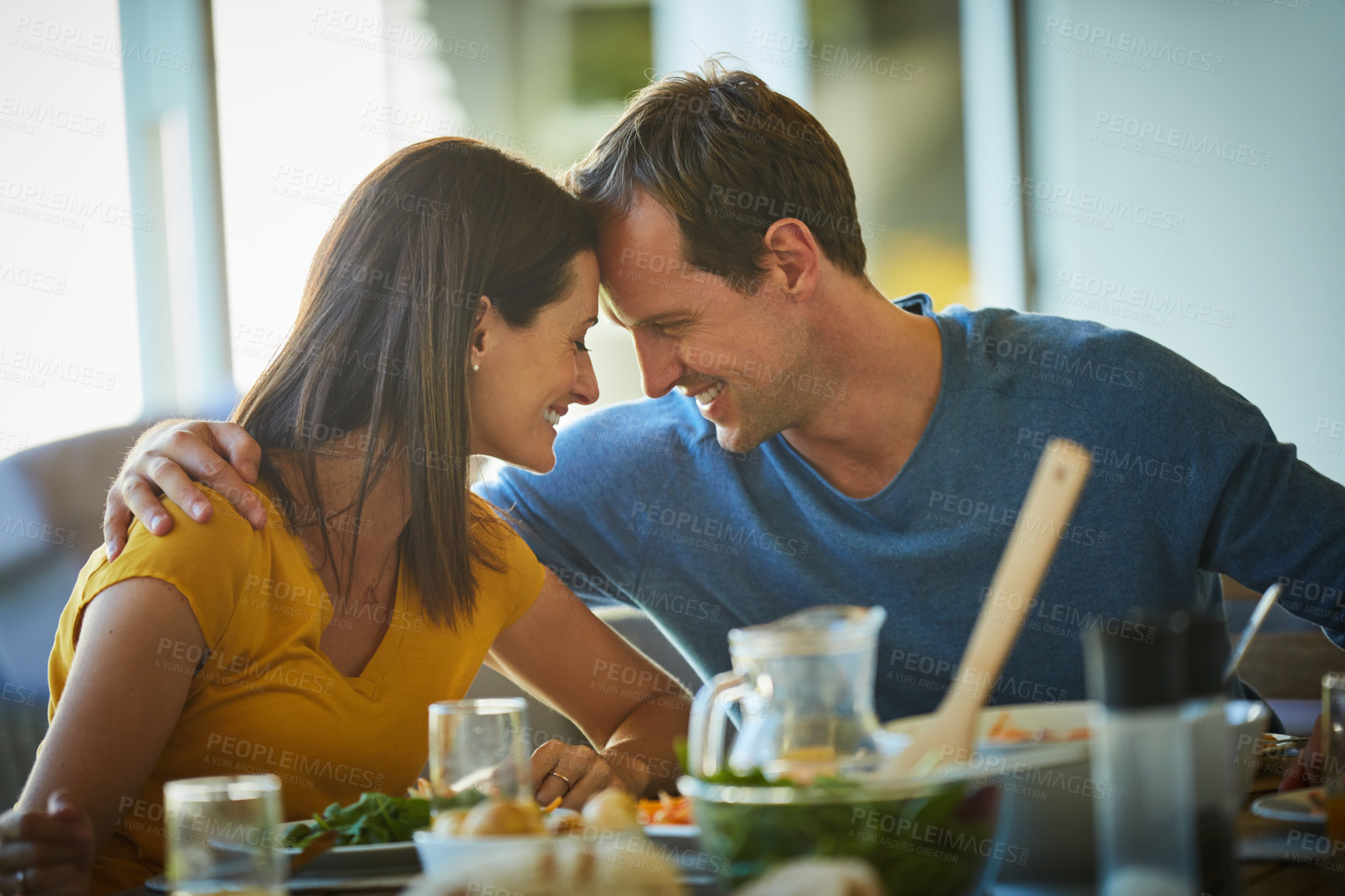 Buy stock photo Cropped shot of a mature couple enjoying a meal together at home