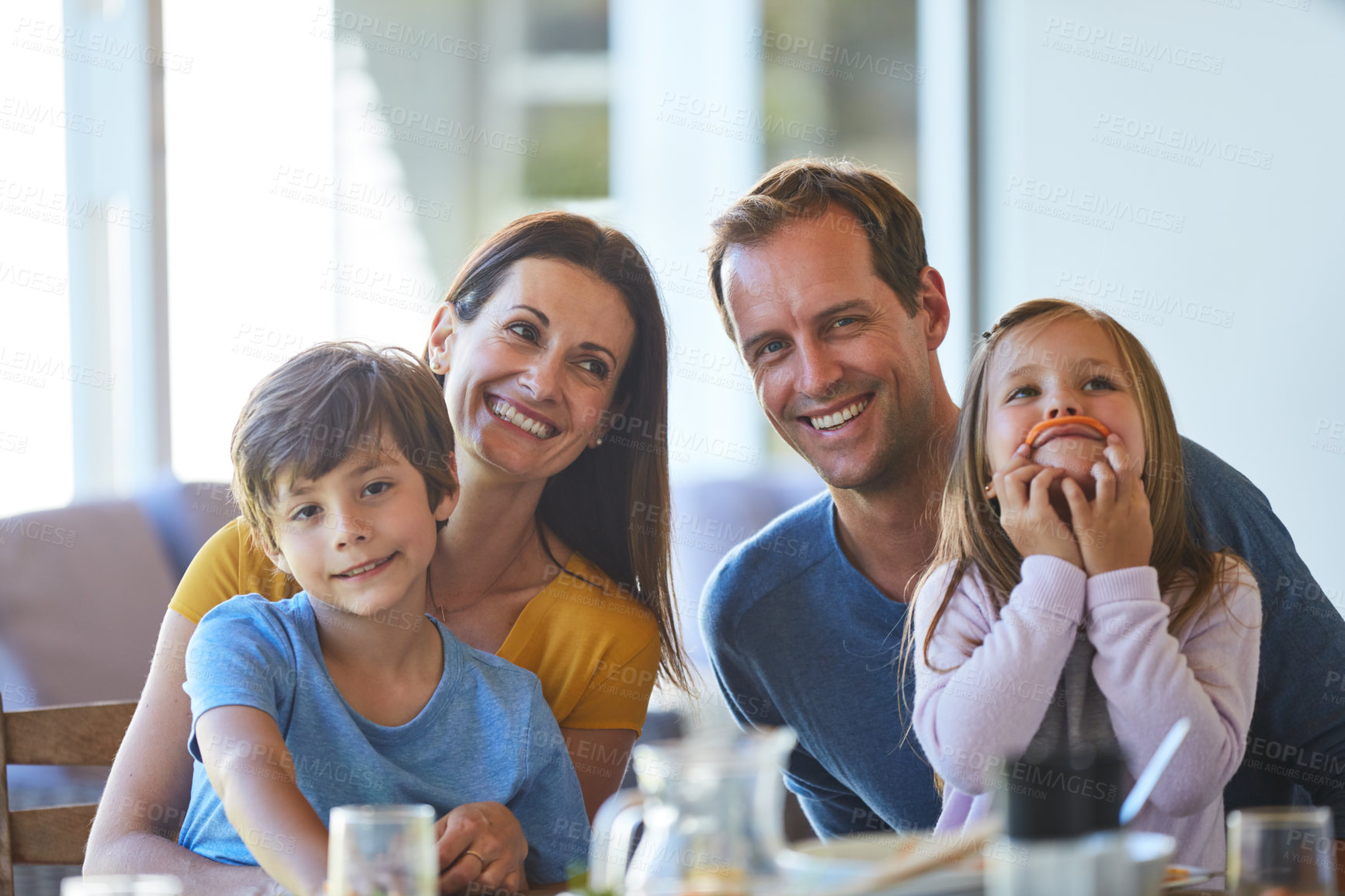 Buy stock photo Portrait of a family enjoying a meal together at home