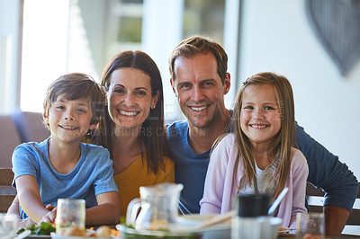Buy stock photo Portrait of a family enjoying a meal together at home