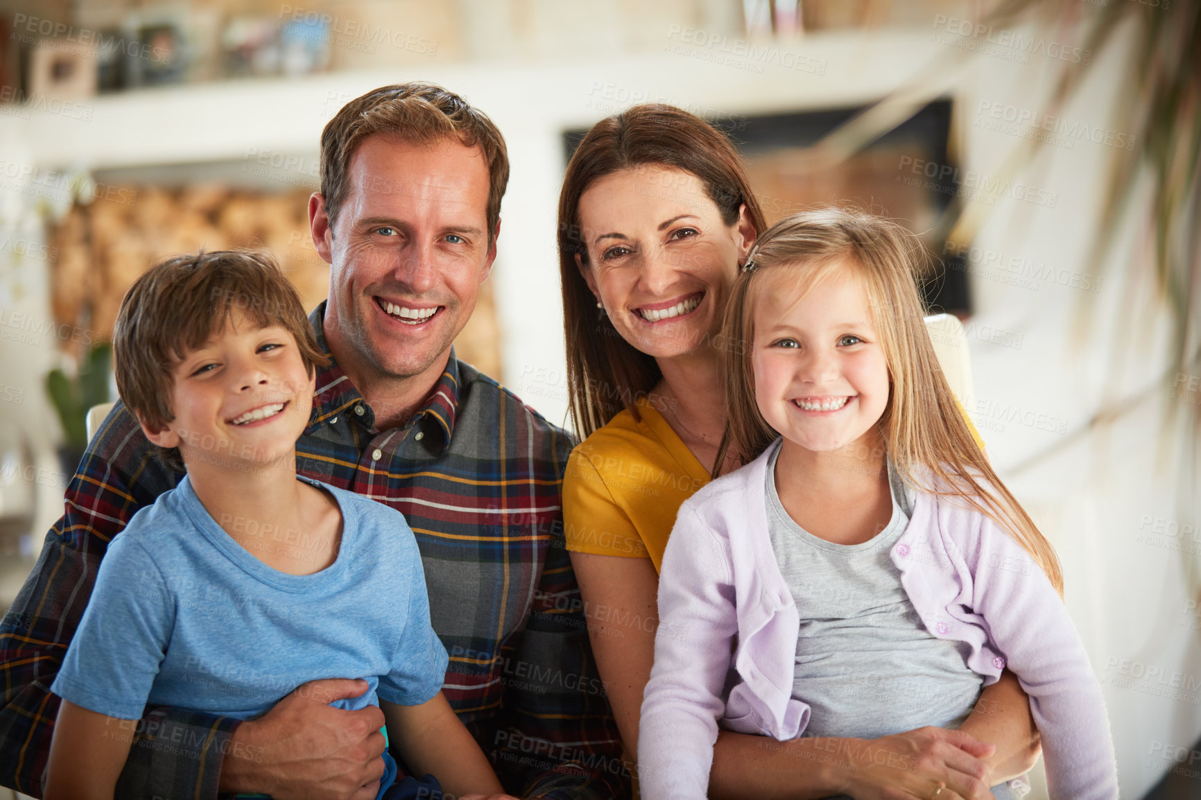 Buy stock photo Portrait of a happy family relaxing together at home