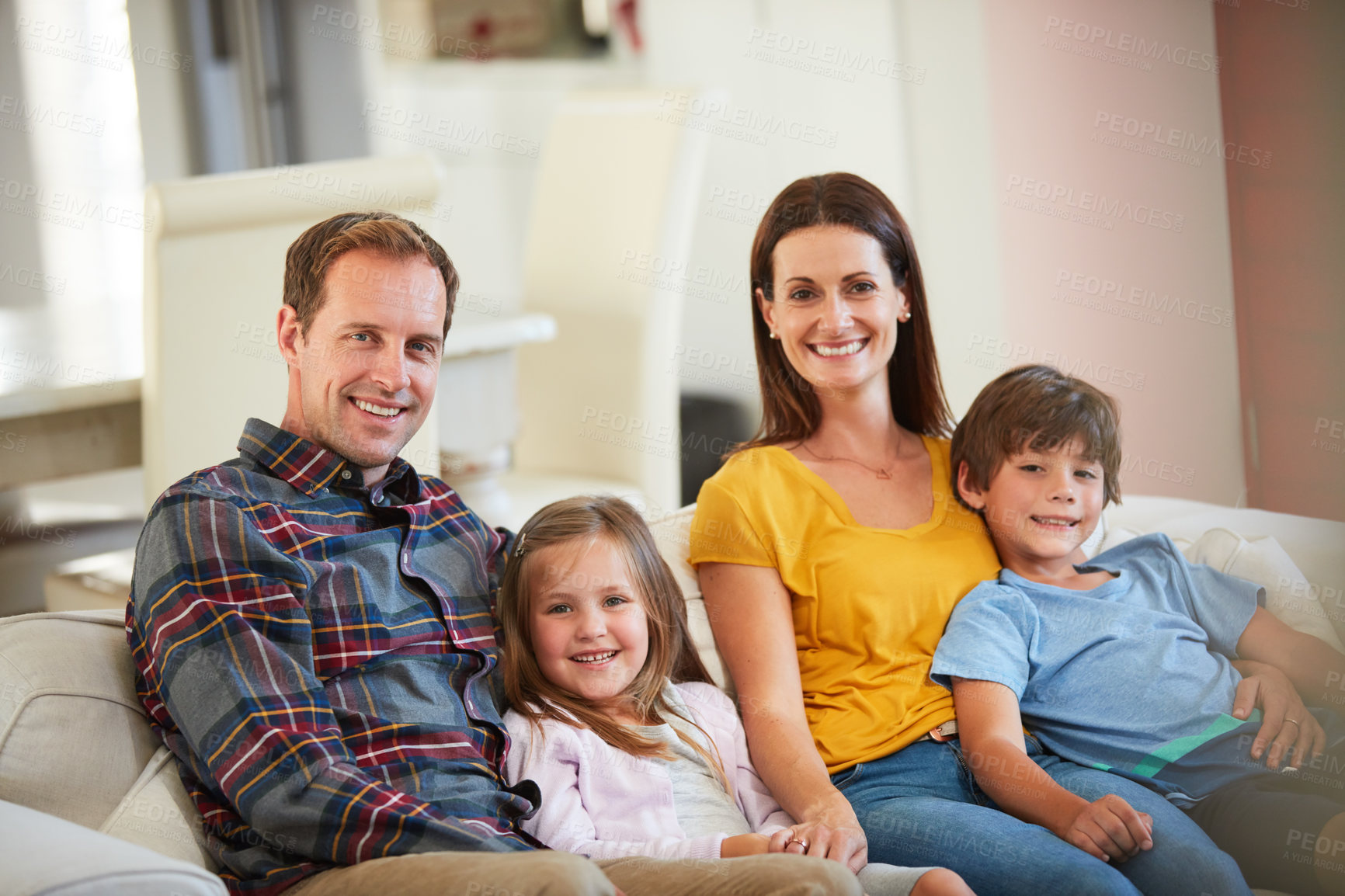 Buy stock photo Portrait of a happy family relaxing together at home