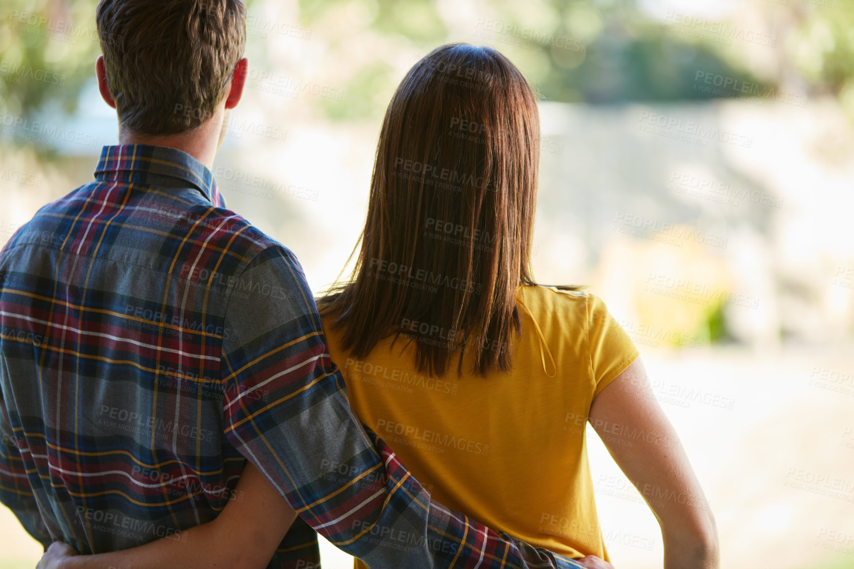 Buy stock photo Rearview shot of a couple looking at the open space in their yard