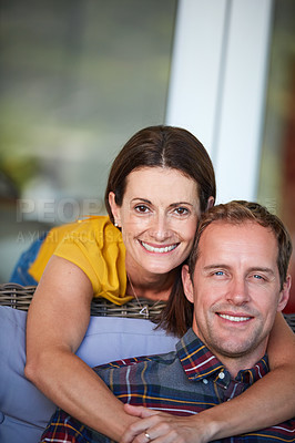 Buy stock photo Cropped shot of a woman hugging her husband from behind