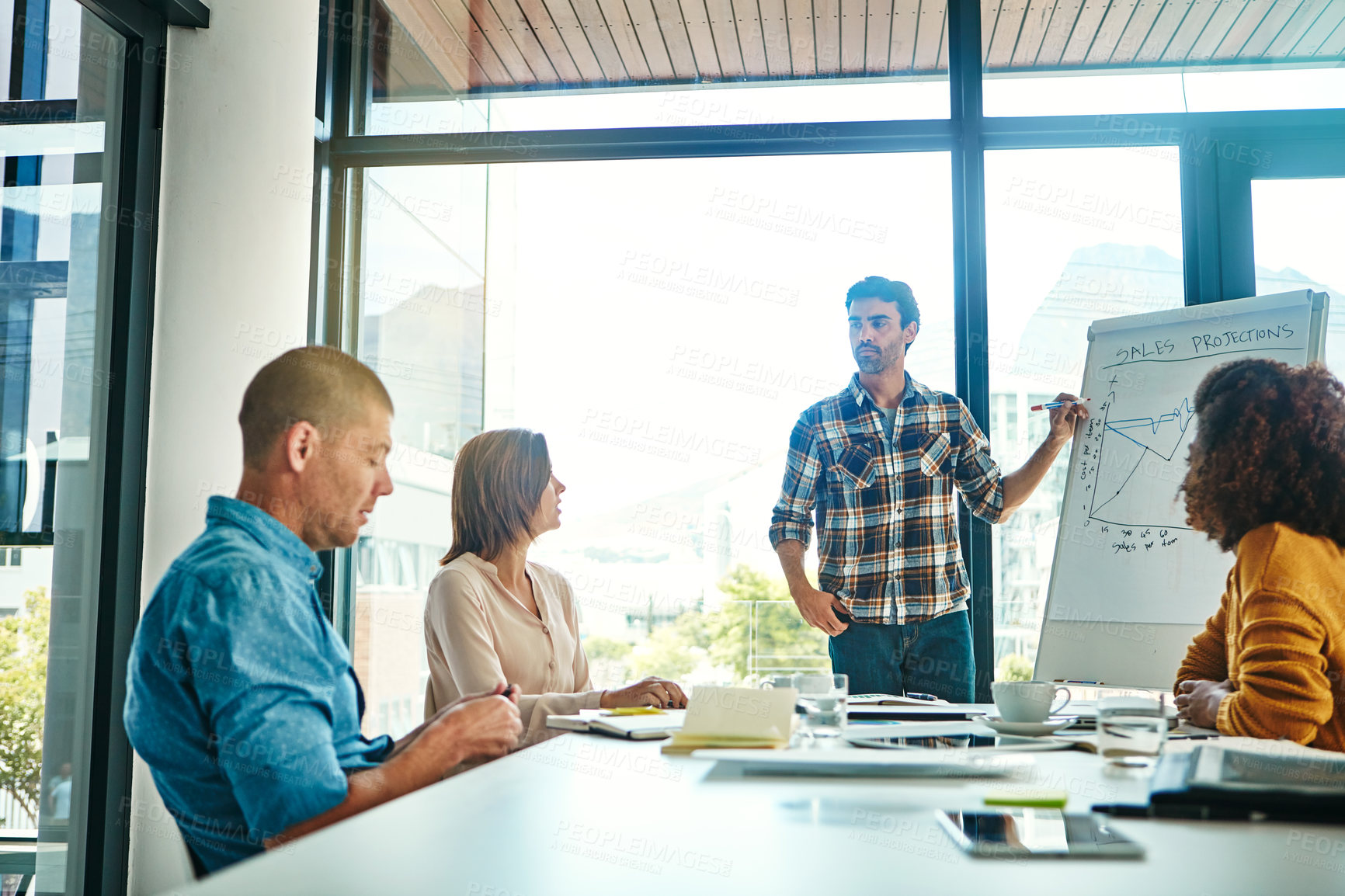 Buy stock photo Cropped shot of a young businessman giving a presentation in the boardroom