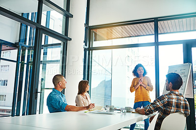 Buy stock photo Shot of colleagues working together in a modern office