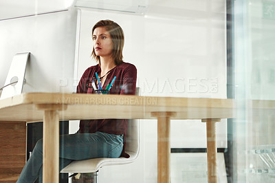 Buy stock photo Cropped shot of a young female designer working at her desk in the office