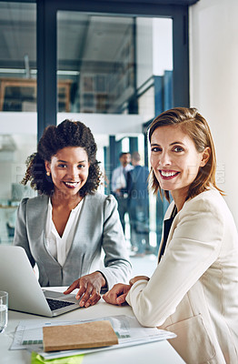 Buy stock photo Portrait of a two corporate businesswomen working together in an office