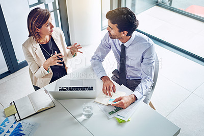 Buy stock photo Cropped shot of two corporate businesspeople having a discussion in an office