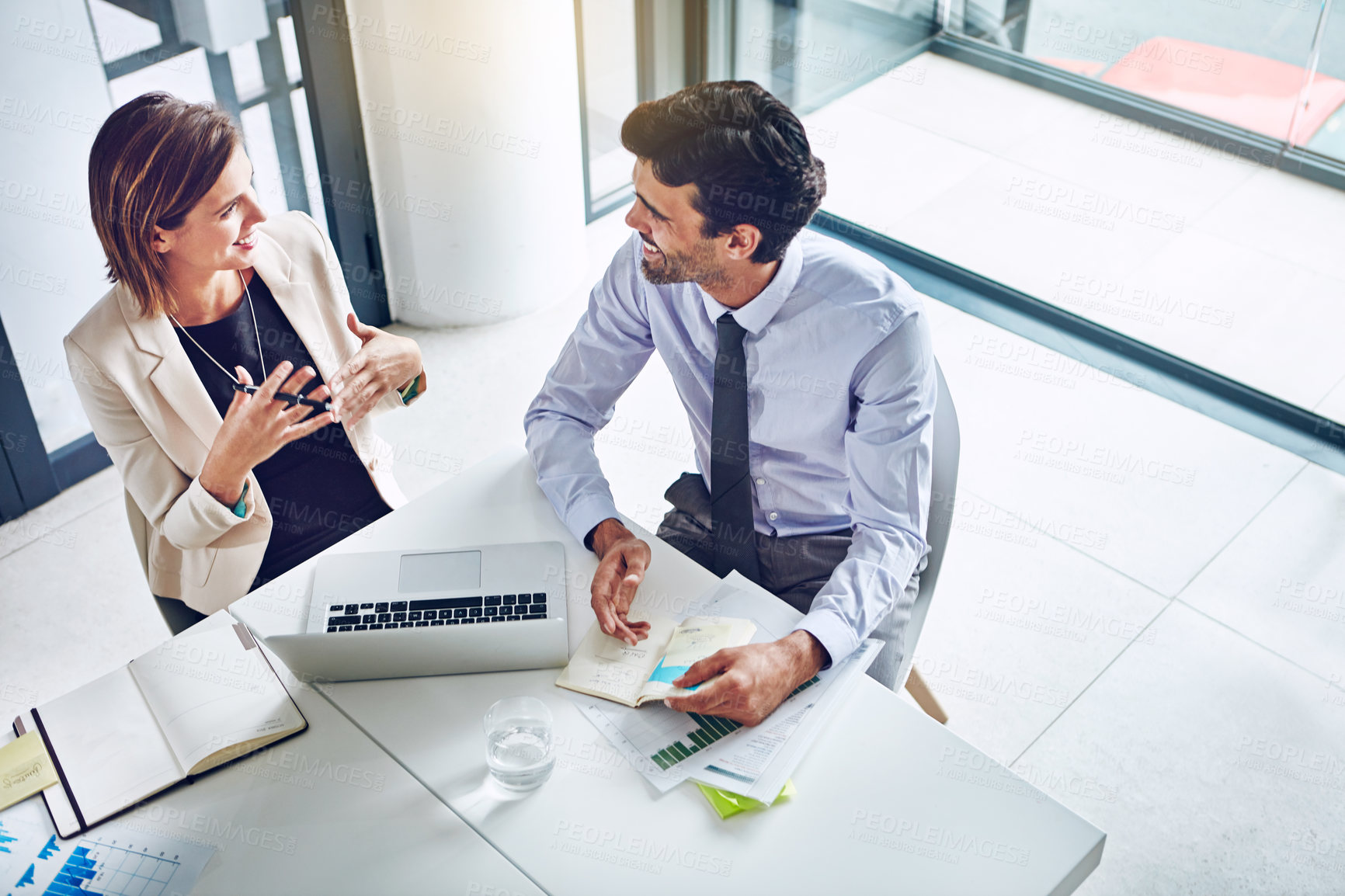 Buy stock photo Cropped shot of two corporate businesspeople having a discussion in an office