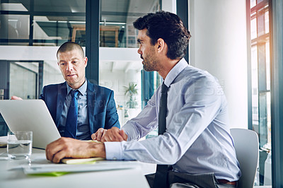 Buy stock photo Cropped shot of two corporate businessmen having a discussion in an office