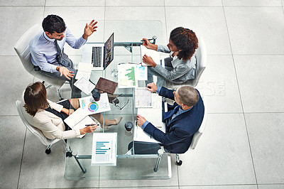 Buy stock photo High angle shot of a group of colleagues working together on a project in a modern office
