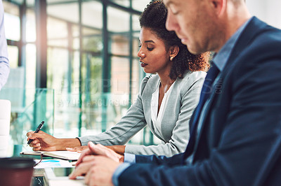 Buy stock photo Cropped shot of two corporate businesspeople working together in an office